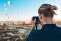 Young man photographer making pictures of air balloons at sunrise time in Cappadocia Royalty Free Stock Photo