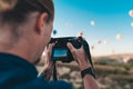 Young man photographer making pictures of air balloons at sunrise time in Cappadocia Royalty Free Stock Photo