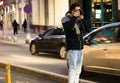 Young man, photographer, in the middle of the street taking a photo of the traffic at rush hour in Bucharest, Romania, 2020 Royalty Free Stock Photo