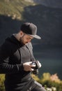 Young  man photographer taking photographs with digital camera in a mountains Royalty Free Stock Photo