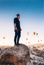 Young man photographer on vacation in Turkey Cappadocia looking at the air balloons during Sunrise at Kapadokya Royalty Free Stock Photo