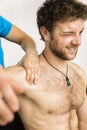 Young man at the physio therapy with pain Royalty Free Stock Photo