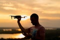 Young man piloting a drone in the evening Royalty Free Stock Photo