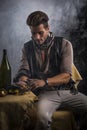 Young Man in Pirate Fashion Outfit Looking at Gold in Hand