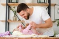 Young man play with laying baby girl Royalty Free Stock Photo