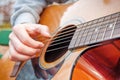 Young man playing acoustic guitar close up outdoors in autumn park Royalty Free Stock Photo