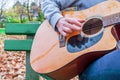 Young man playing acoustic guitar close up outdoors in autumn park Royalty Free Stock Photo