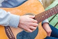 Young man playing acoustic guitar close up outdoors in autumn park Royalty Free Stock Photo