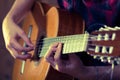 Young man playing acoustic guitar during a concert. - Vintage colours Royalty Free Stock Photo