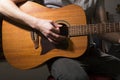 Young man playing on acoustic guitar