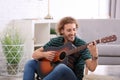 Young man playing acoustic guitar Royalty Free Stock Photo