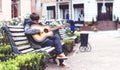 Young man playing on acoustic guitar outdoor Royalty Free Stock Photo