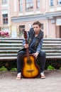 Young man playing on acoustic guitar outdoor Royalty Free Stock Photo