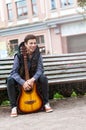 Young man playing on acoustic guitar outdoor Royalty Free Stock Photo