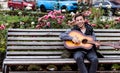 Young man playing on acoustic guitar outdoor Royalty Free Stock Photo