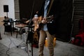 A young man playing an acoustic guitar in the street