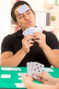 Young man playing cards cuarenta traditional