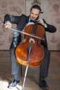 Young man playing the cello. Portrait of the cellist Royalty Free Stock Photo