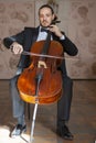 Young man playing the cello. Portrait of the cellist Royalty Free Stock Photo