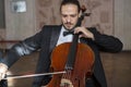 Young man playing the cello. Portrait of the cellist Royalty Free Stock Photo