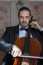 Young man playing the cello. Portrait of the cellist Royalty Free Stock Photo