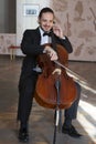 Young man playing the cello. Portrait of the cellist Royalty Free Stock Photo