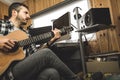 Young man playing classical guitar in studio. Musician guitarist Royalty Free Stock Photo