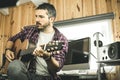 Young man playing classical guitar in studio. Musician guitarist Royalty Free Stock Photo