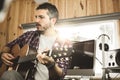 Young man playing classical guitar in studio. Musician guitarist Royalty Free Stock Photo