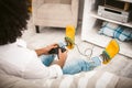 Young man playing computer game. Gamer Remove the buttons on the joystick from the PlayStation in cozy home interior