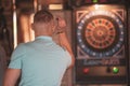 Young man playing darts indoors