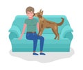 Young man playing with dog sitting on sofa. Calm evening pastime concept