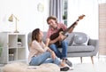 Young man playing electric guitar for his girlfriend Royalty Free Stock Photo