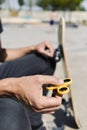 Young man playing with a fidget spinner Royalty Free Stock Photo