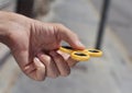 Young man playing with a fidget spinner Royalty Free Stock Photo