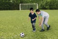 Young man playing football with his son Royalty Free Stock Photo