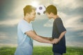 Young man playing football with his son Royalty Free Stock Photo
