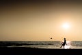 Young man playing football silhouette ocean horizon sunset horiz Royalty Free Stock Photo