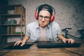 Young man playing game at home and streaming playthrough or walkthrough video Royalty Free Stock Photo