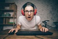 Young man playing game at home and streaming playthrough or walkthrough video Royalty Free Stock Photo