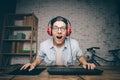 Young man playing game at home and streaming playthrough or walkthrough video Royalty Free Stock Photo