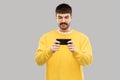 Young man playing game on smartphone Royalty Free Stock Photo