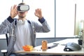 Young man playing game using virtual reality headset in the playing club Royalty Free Stock Photo