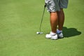 Young Man Playing Golf making a Putt Royalty Free Stock Photo