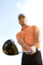 Young man playing golf, low angle view Royalty Free Stock Photo