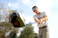 Young man playing golf, low angle view Royalty Free Stock Photo