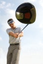 Young man playing golf, low angle view Royalty Free Stock Photo