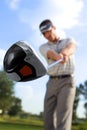 Young man playing golf, low angle view Royalty Free Stock Photo