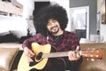 Young man playing guitar at home Royalty Free Stock Photo