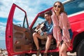 young man playing guitar near car with cheerful girlfriend Royalty Free Stock Photo